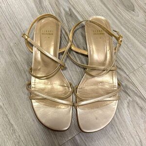Gold Stuart Weitzman strappy sandals.